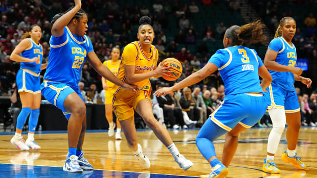 USC Trojans guard JuJu Watkins drives the lane between UCLA Bruins forward Christeen Iwuala and guard Londynn Jones.